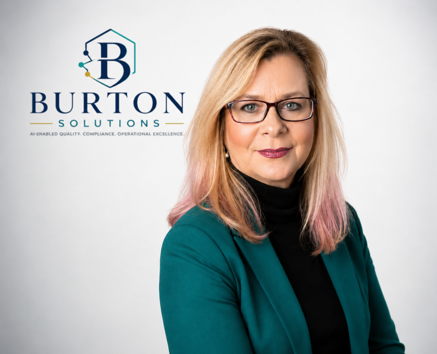 A woman with blonde and pink hair wearing glasses, a black turtleneck, and a teal blazer, standing in front of a white background with the Burton Solutions logo and slogan.