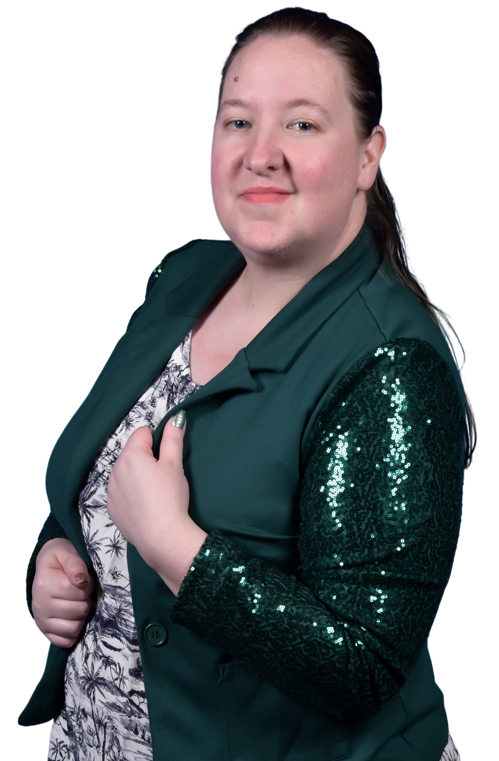 Portrait of a person wearing a dark green blazer with sequin sleeves, a patterned blouse, and showing a confident pose with a slight smile.