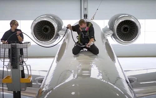 Workers performing maintenance on an aircraft by Aesthetic Aviation Detailing in Chicago.