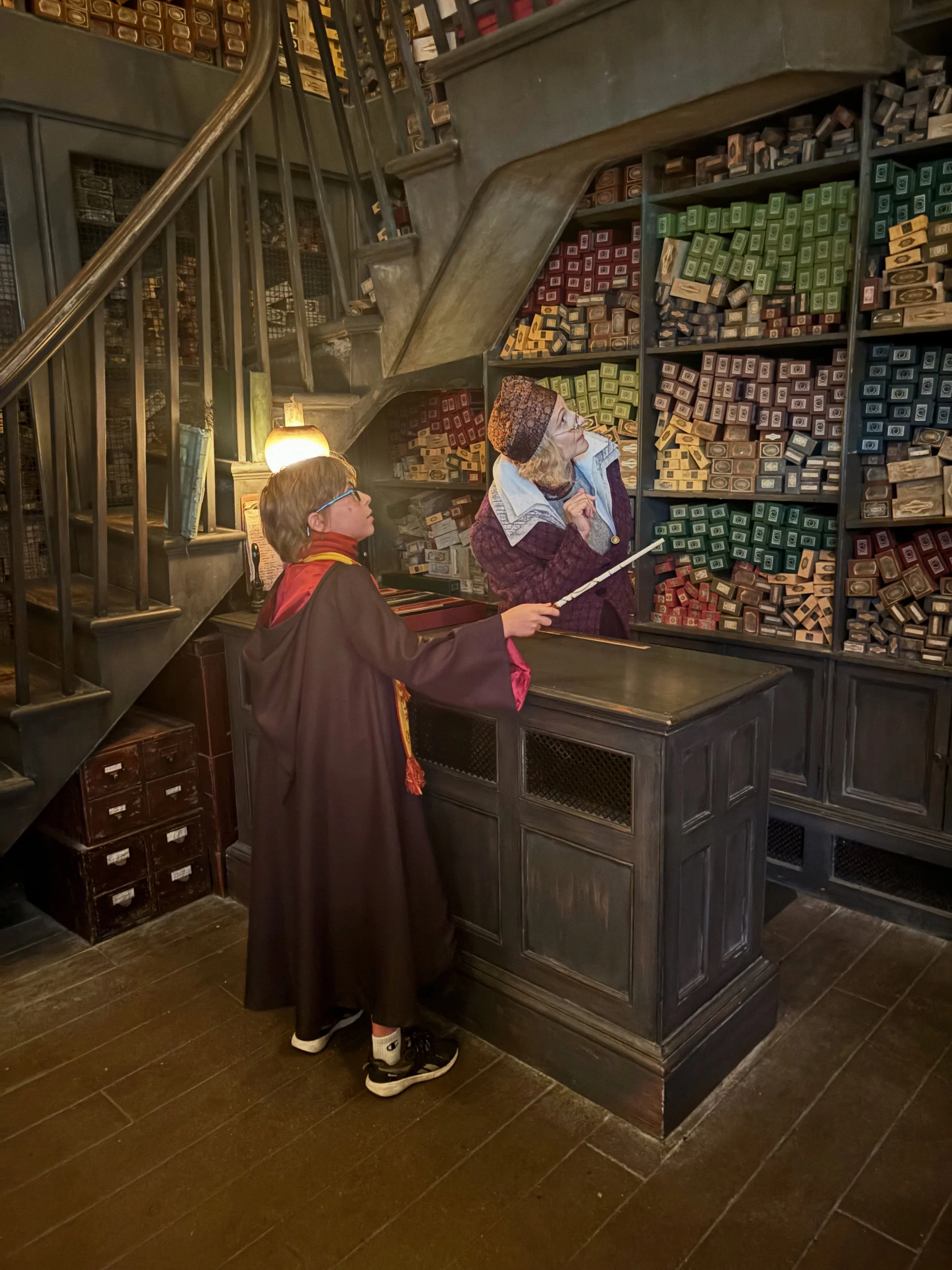 The Wand Ceremony at Ollivanders is one of my most magical memories from Universal Studios. After the official ceremony, our party was asked to stay while the other groups left the room, and my Gryffindor had a private ceremony to choose a wand of hi