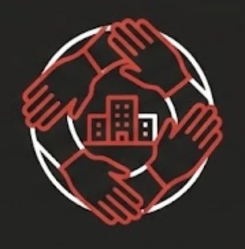 Four interconnected hands surrounding a cityscape inside a circle, symbolizing community or collaboration.