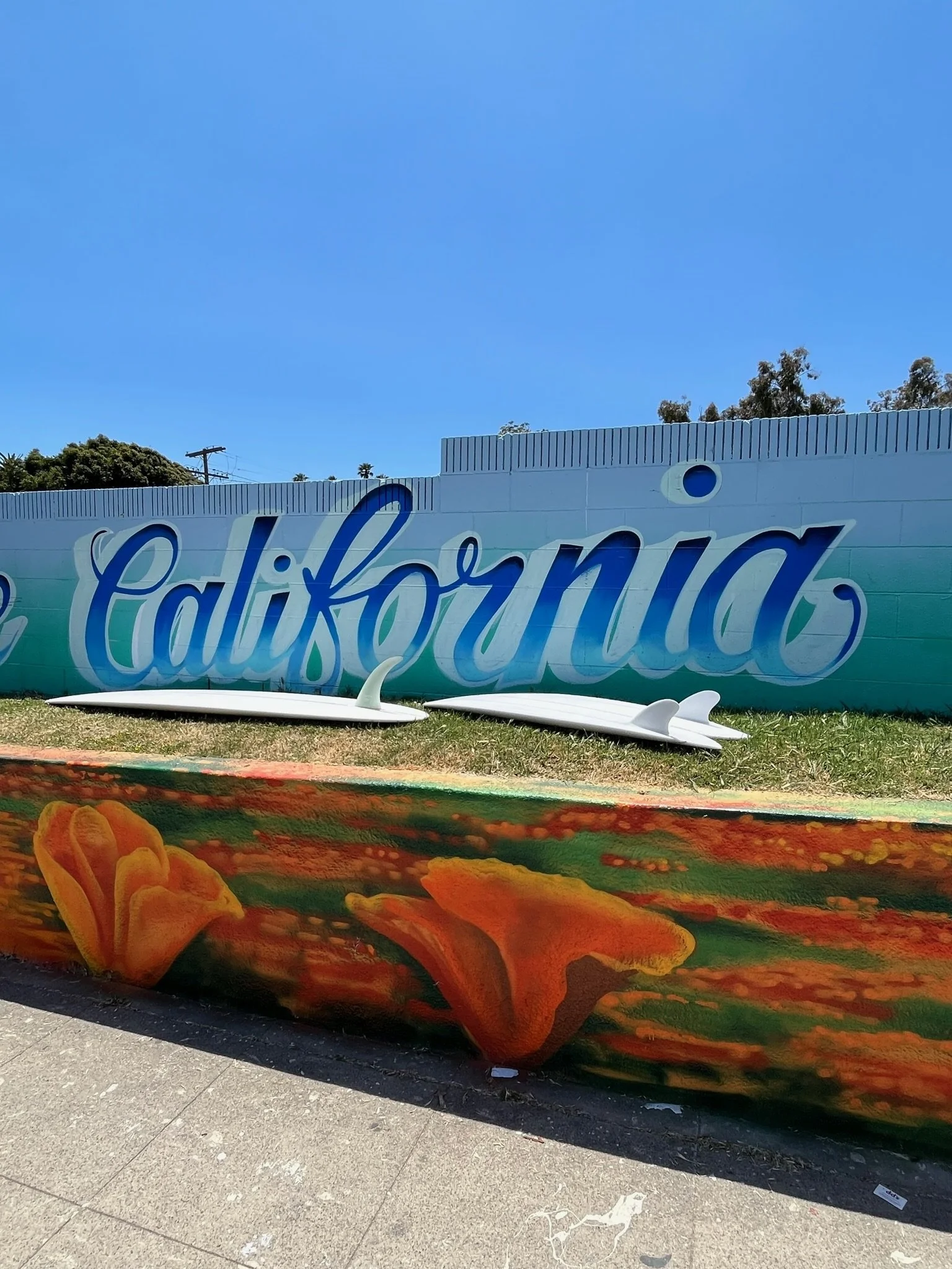 Part of a colorful mural with the word 'Californian' written in large blue cursive letters.