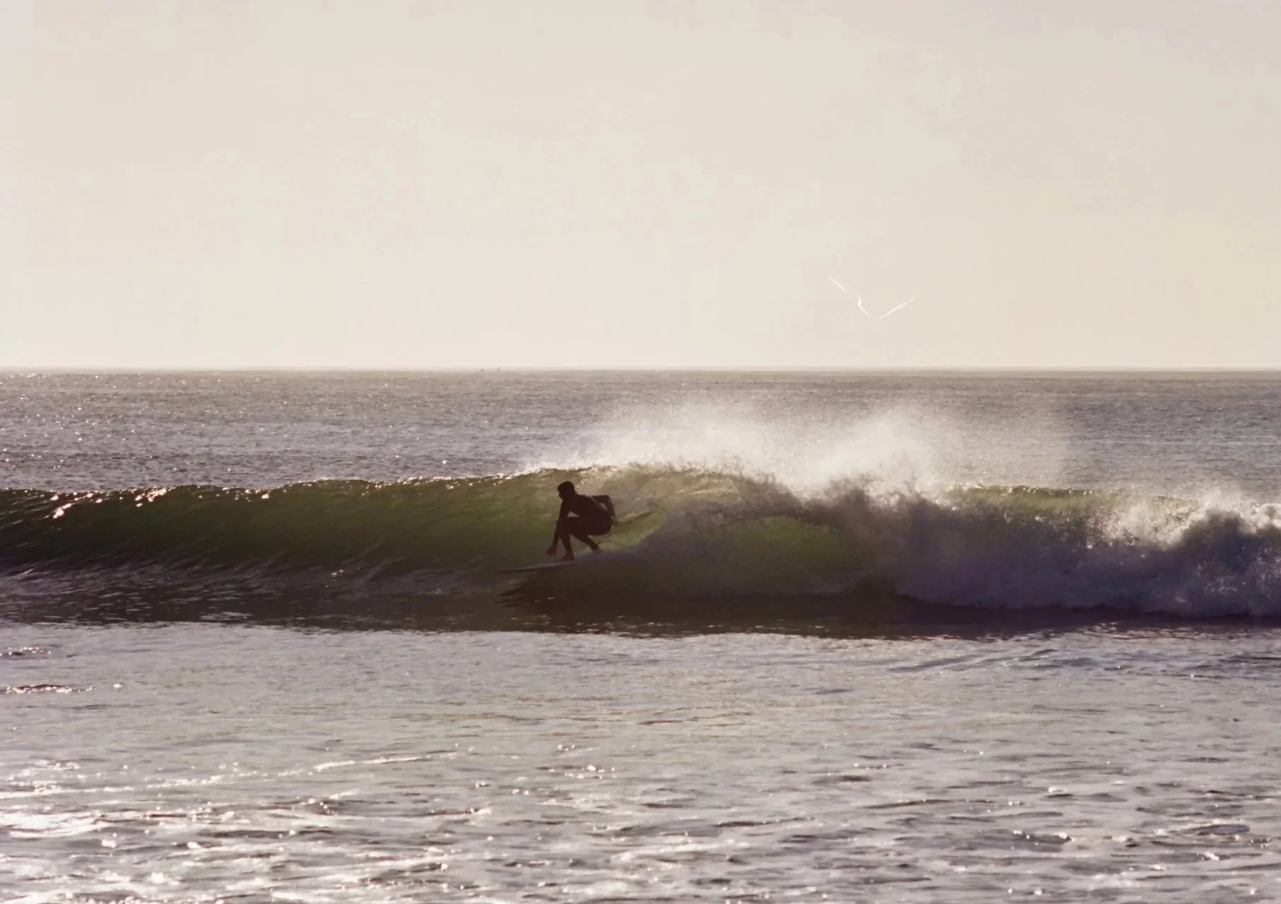35 mm photo shot at Rincon surfing an 8'2 Wyatt Pender hand-shaped displacement hull. Glassed by Tim Leckington