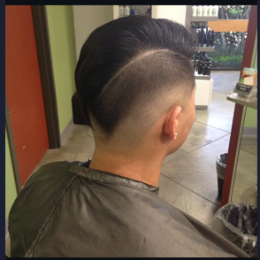 Person with a modern undercut hairstyle sitting in a salon