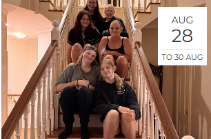 Group of six young women sitting on a staircase indoors