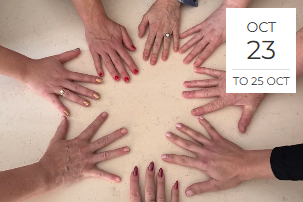 Multiple hands with painted nails arranged in a circle on a table.