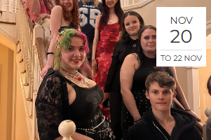 Group of seven young women and one young man, dressed in semi-formal attire, posing on a staircase indoors.