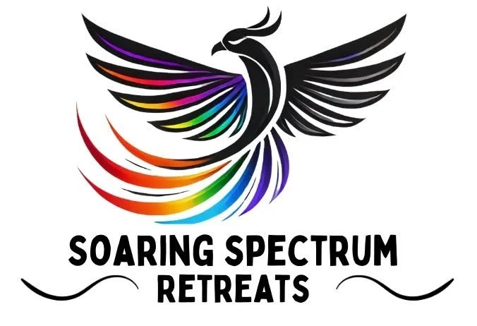 A colorful phoenix with wings spread, displaying a rainbow spectrum of colors, above the text "Soaring Spectrum Retreats."