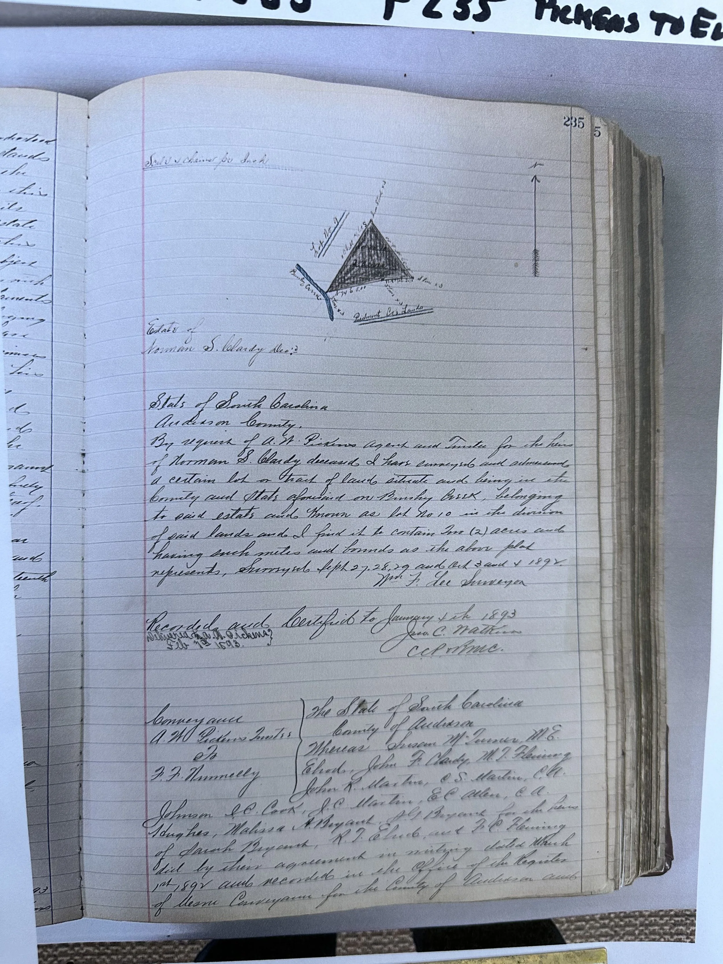 A handwritten historical land deed document with a small geometric diagram at the top, including handwritten notes and signatures.