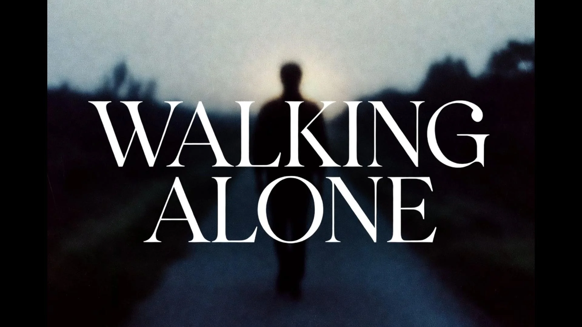 A silhouette of a person walking alone on a dark road during dusk or dawn, with the text "Walking Alone" overlayed in large white letters.