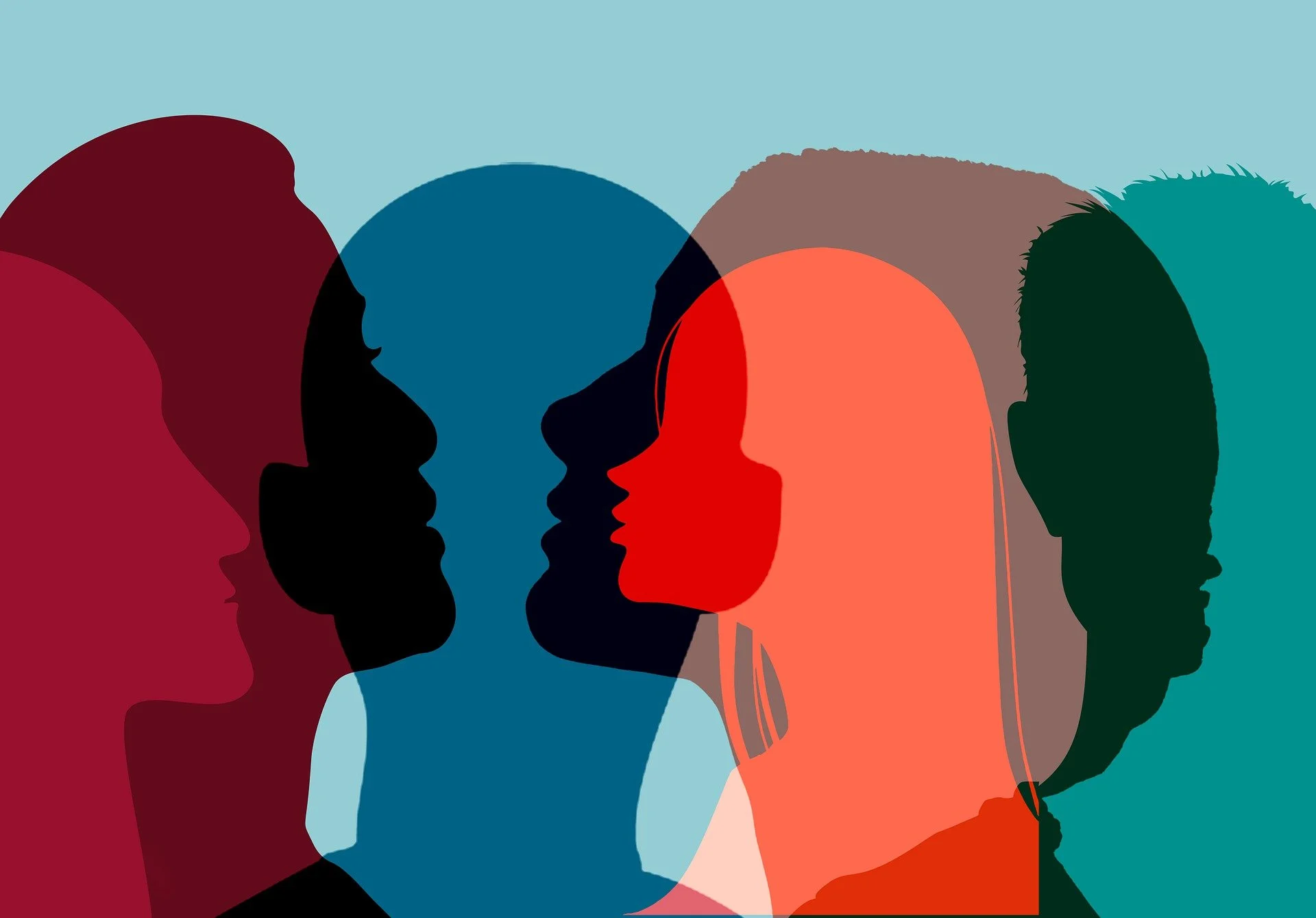 Silhouettes of diverse faces overlapping in multiple colors.