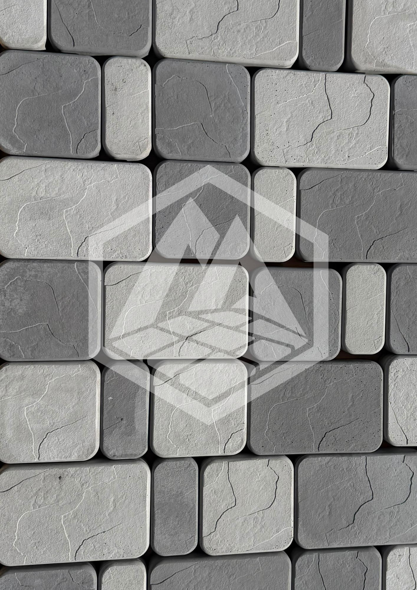 Close-up view of a wall made of rectangular ceramic tiles with a stone-like texture and visible cracks, arranged in a grid pattern with light grout lines.