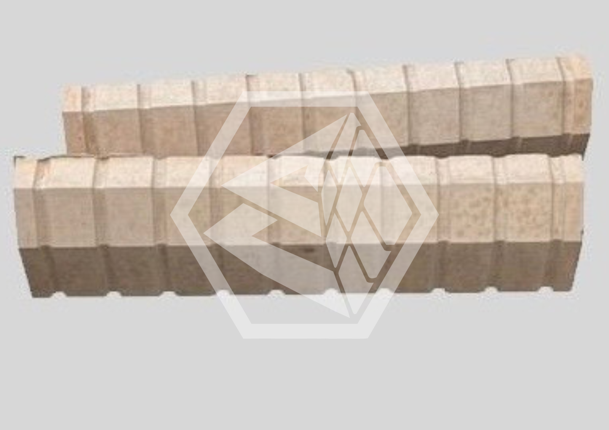 Close-up of a relief sculpture featuring stylized, intertwined human profiles carved into a beige stone surface.