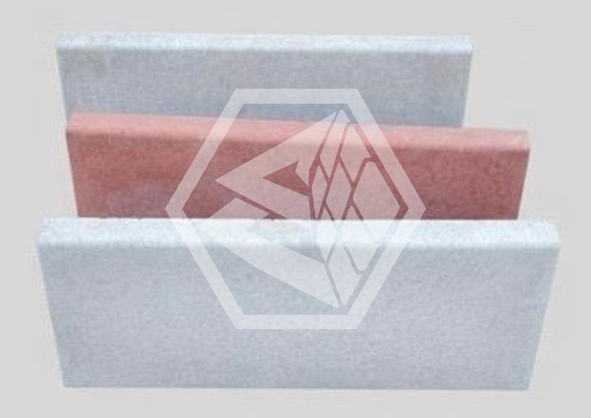 A rectangular block with a pink top layer and a gray bottom layer, resting on a white surface with a gray background.