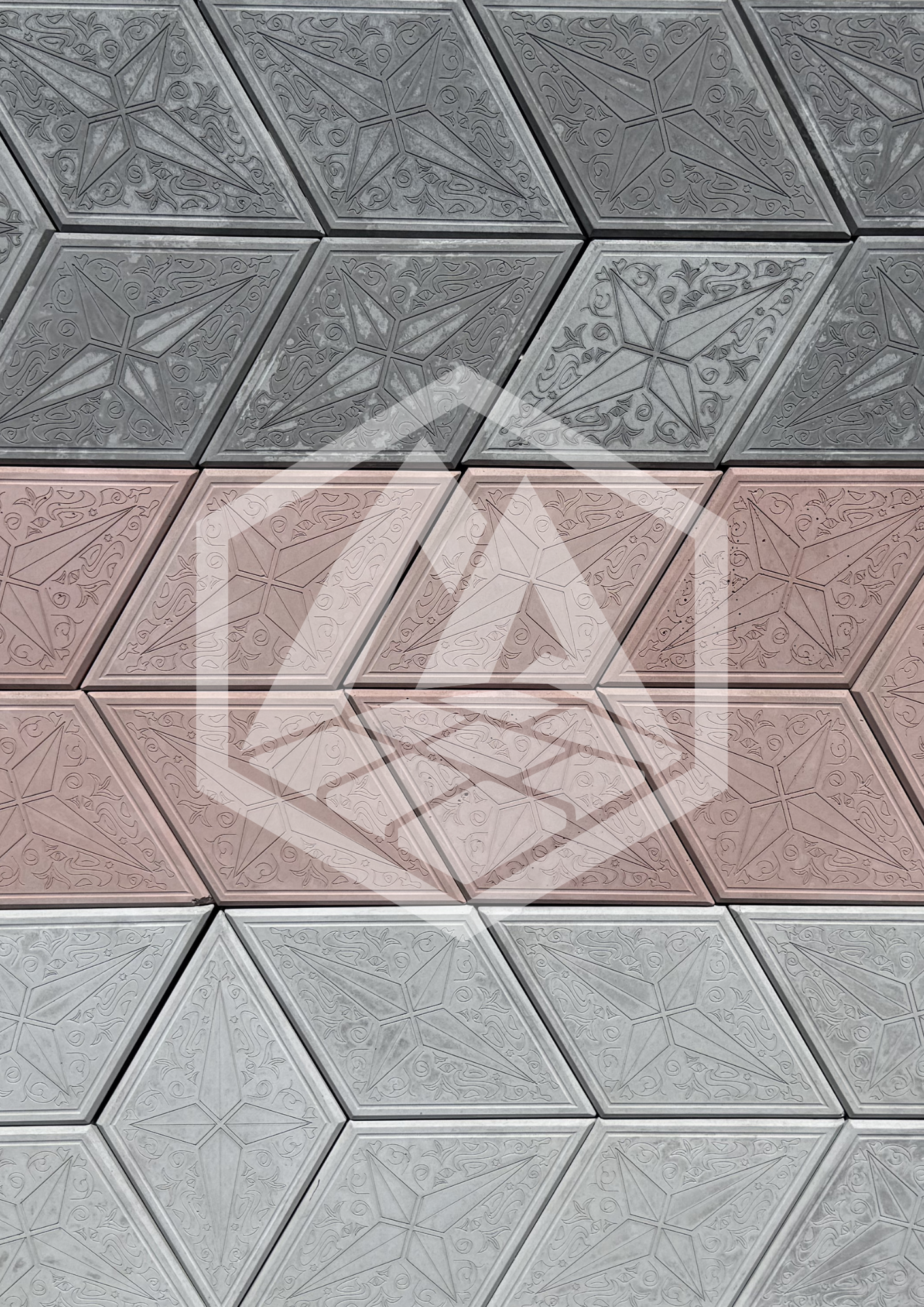 Close-up of a ceiling with decorative square tiles featuring intricate floral and star patterns.