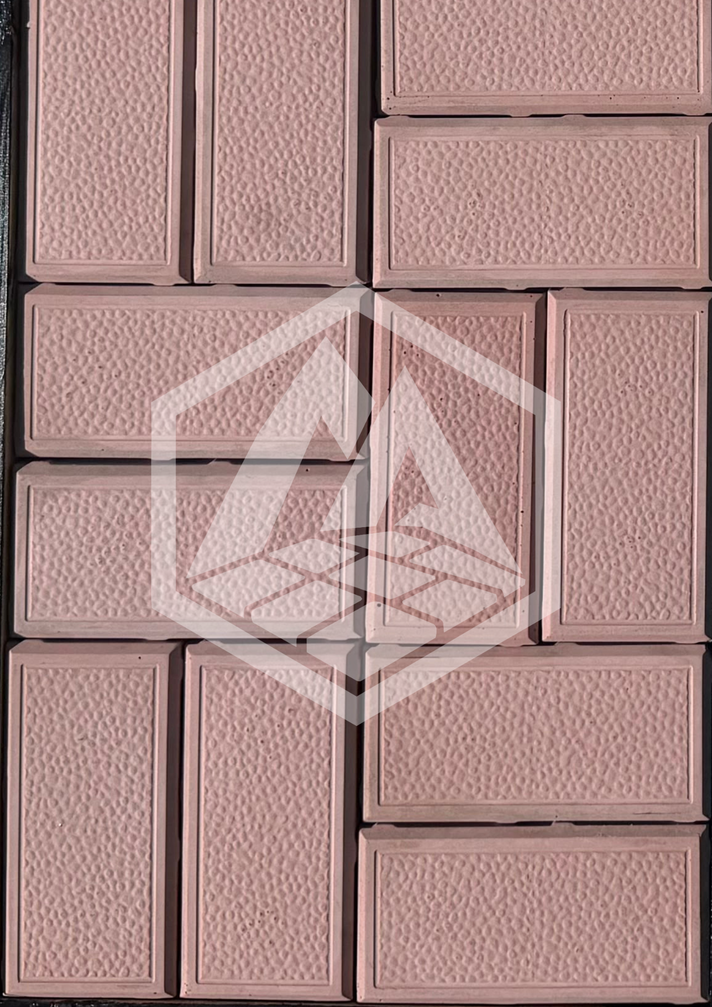 Close-up of a pink brick wall with textured surface.