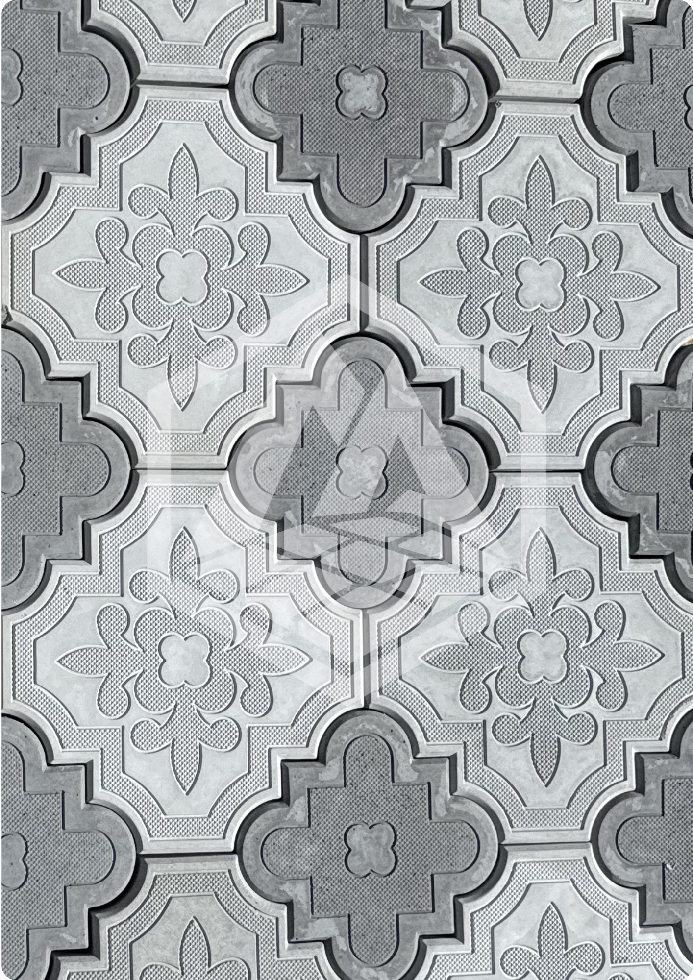 Gray and white ceramic patterned floor tiles with intricate floral and geometric designs.