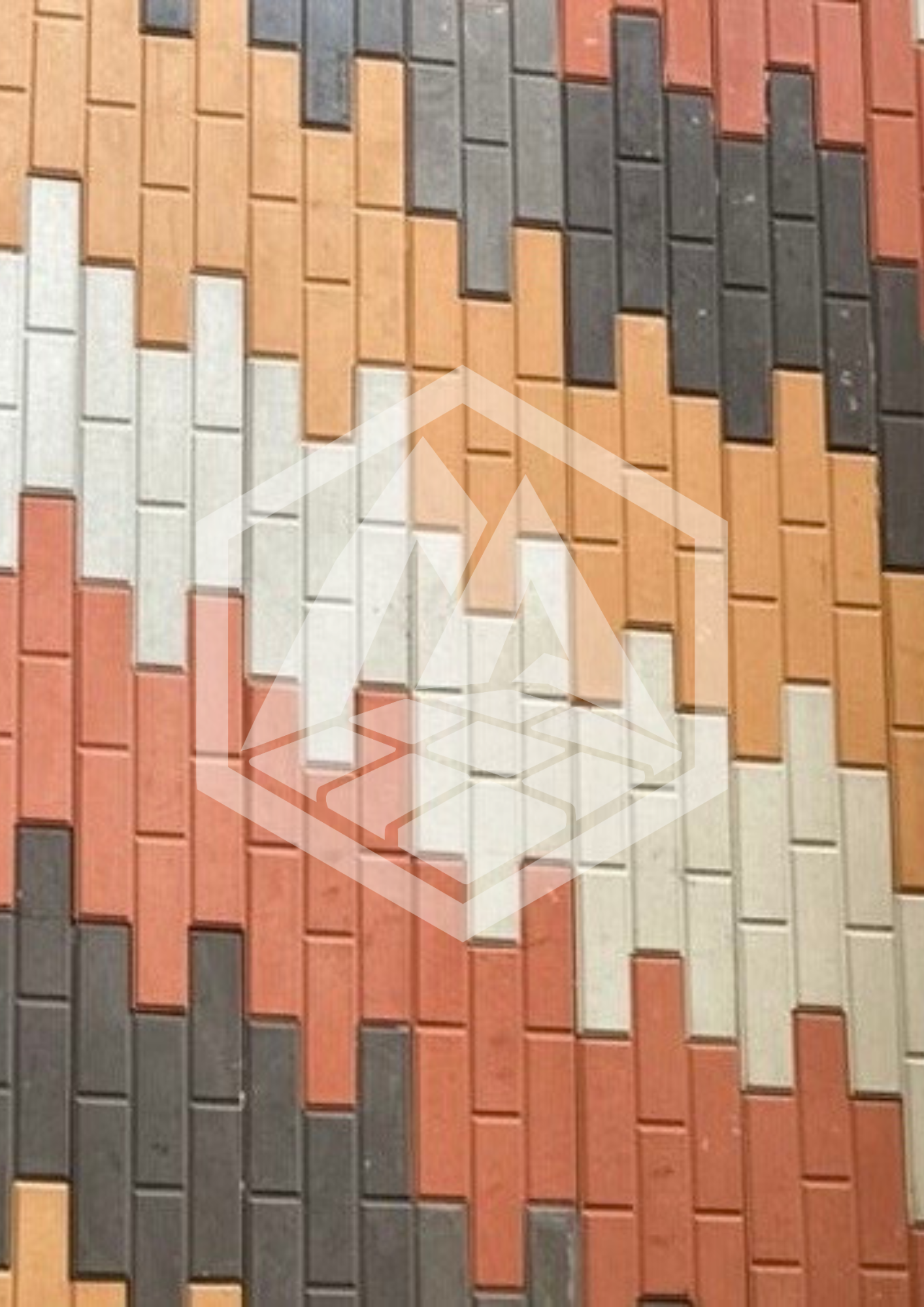 Close-up of brick wall with bricks in various shades of red, orange, beige, gray, and black arranged in a staggered pattern.