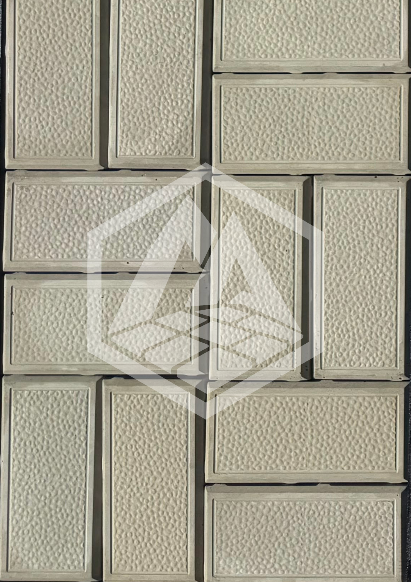 Close-up of cream-colored textured wall tiles with rectangular shapes and beveled borders.