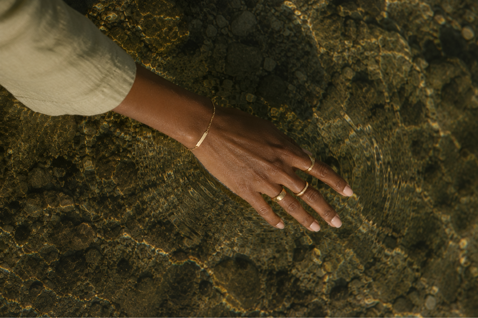 WOMAN TOUCHING WATER