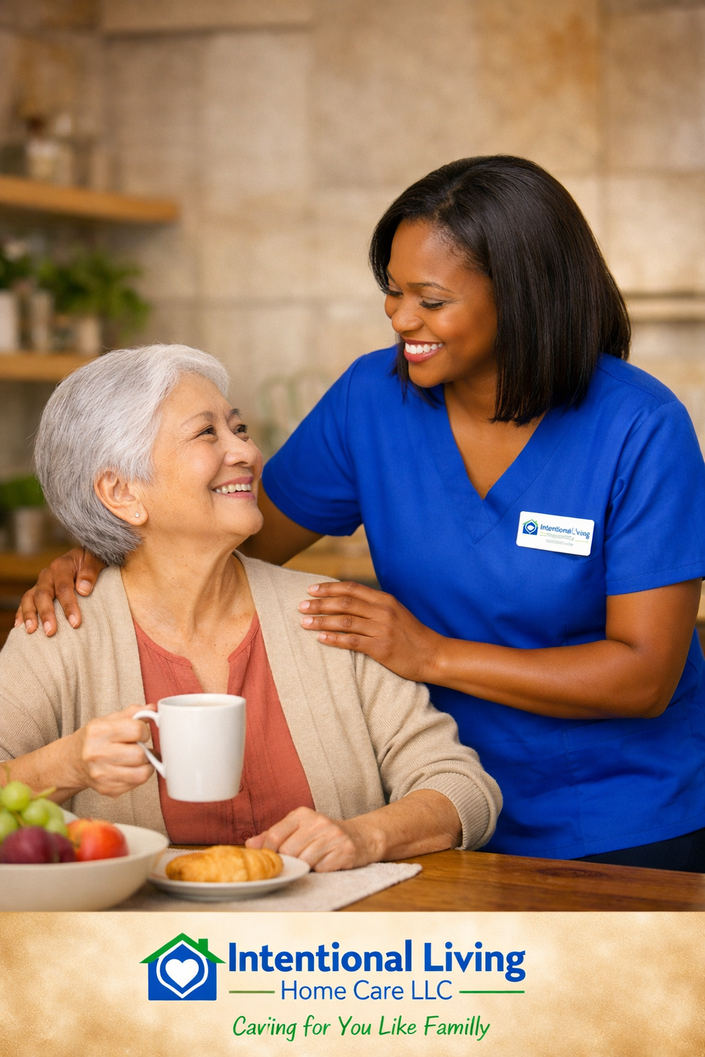 A caregiver and an elderly woman smiling at each other at breakfast, with a bowl of fruit and a croissant on the table, in a cozy home setting.