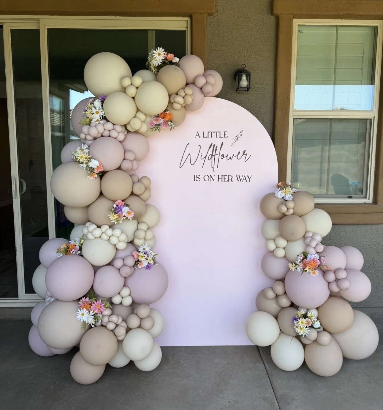 'A little wildflower is on her way' Baby Shower with pastel pink and neutral balloons and wildflower accents