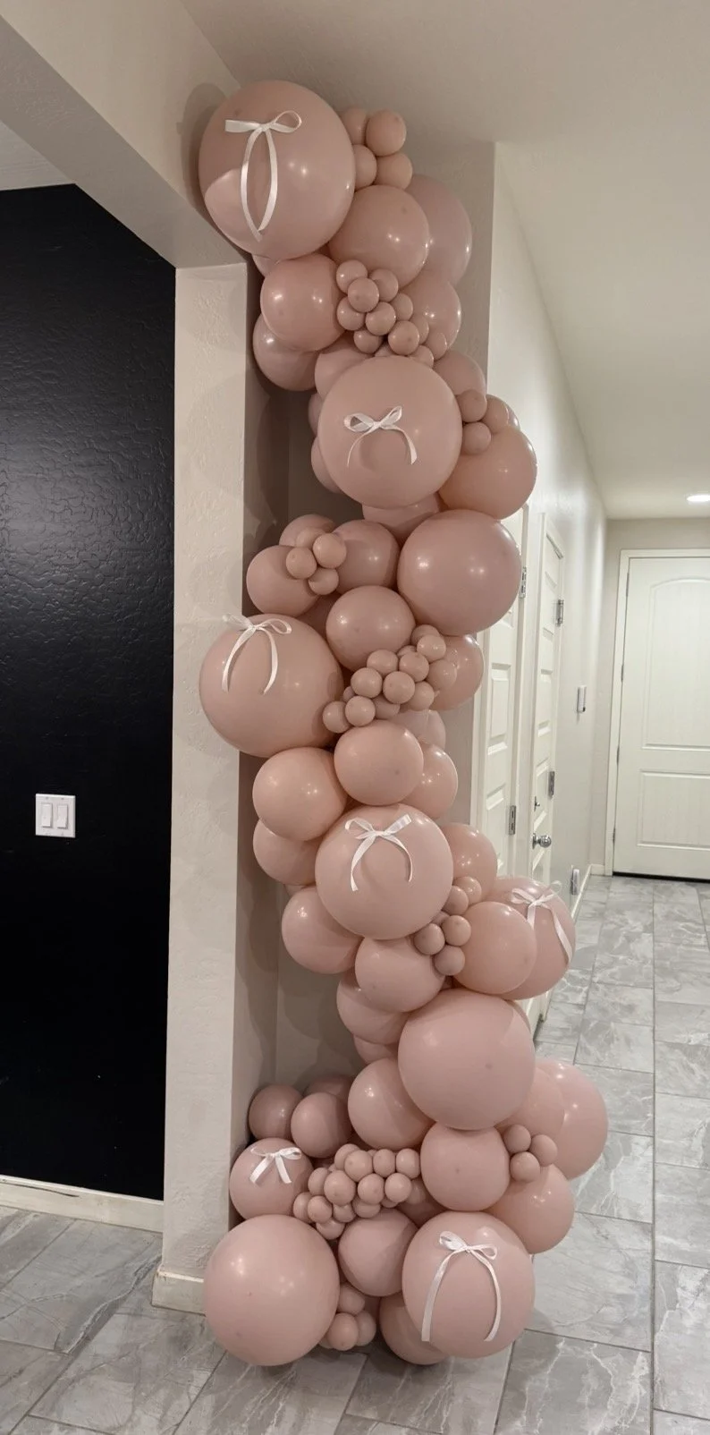 Blush Pink balloon garland with delicate white bow accents