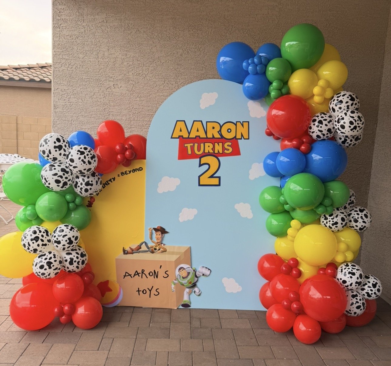 Toy Story Balloons & backdrop featuring colorful balloons, toy box, Woody & Buzz props