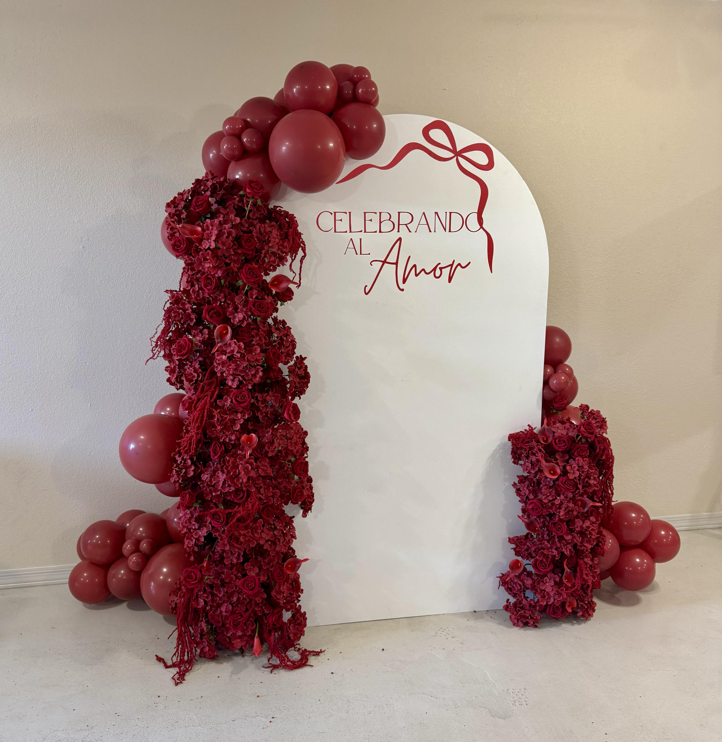 Elegant deep red balloons and floral arrangements for a Valentine's celebration