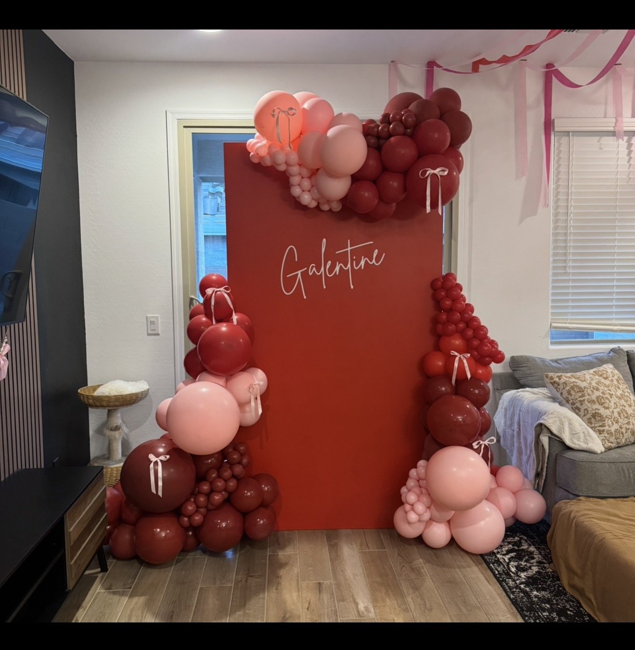 Pink and red balloons with bow accents for the perfect 'Galentines' celebration