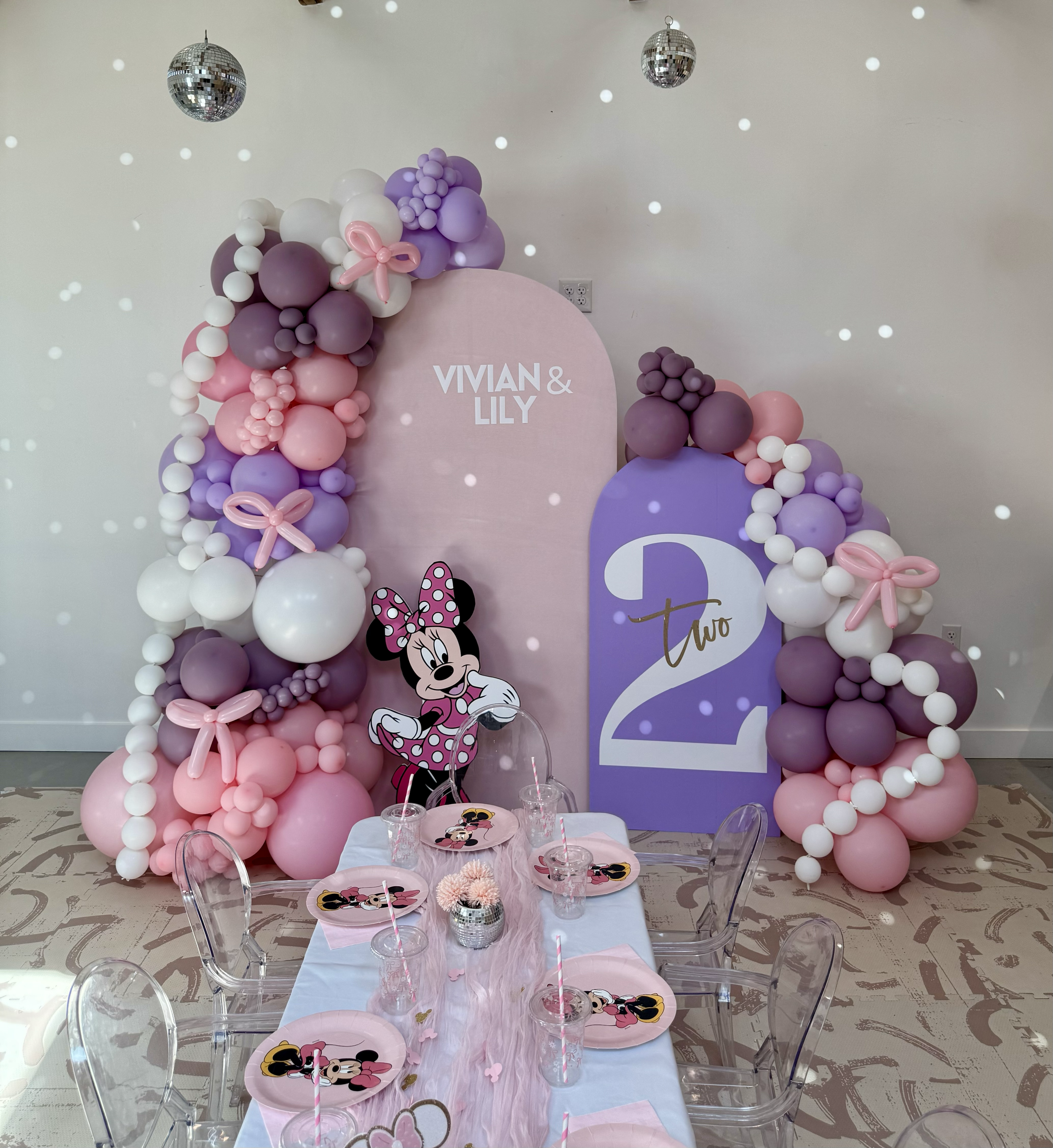 Oh Toodles! Minnie Mouse second birthday party featuring pink and dusty purple balloons, backdrops, and Bow & pearl strand accents.