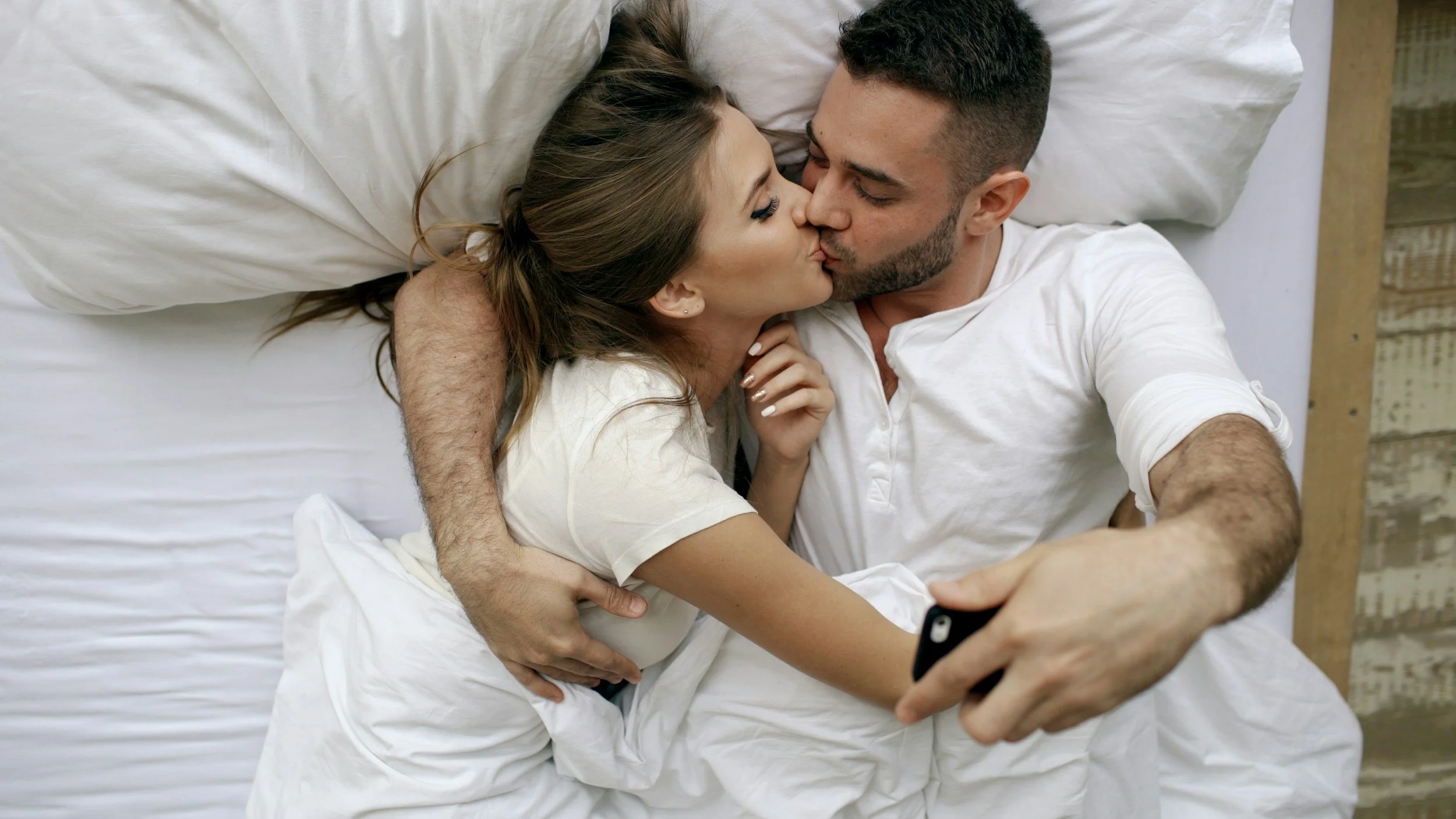 MAN AND WOMAN IN BED enjoying a kiss, marriage therapy, Frisco, TX