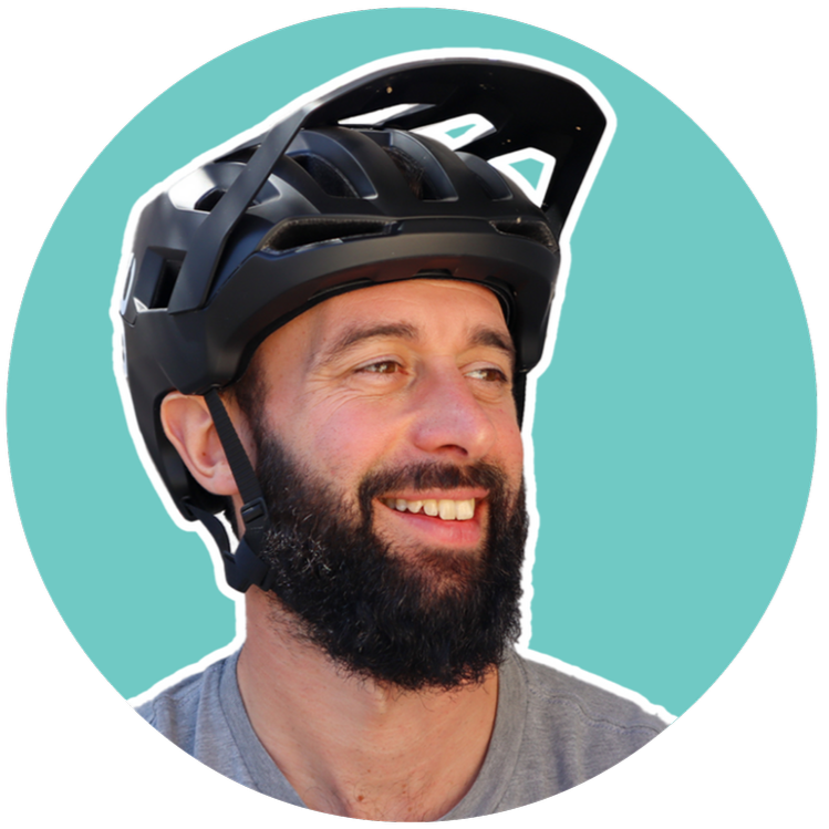 Smiling man wearing a black bicycle helmet