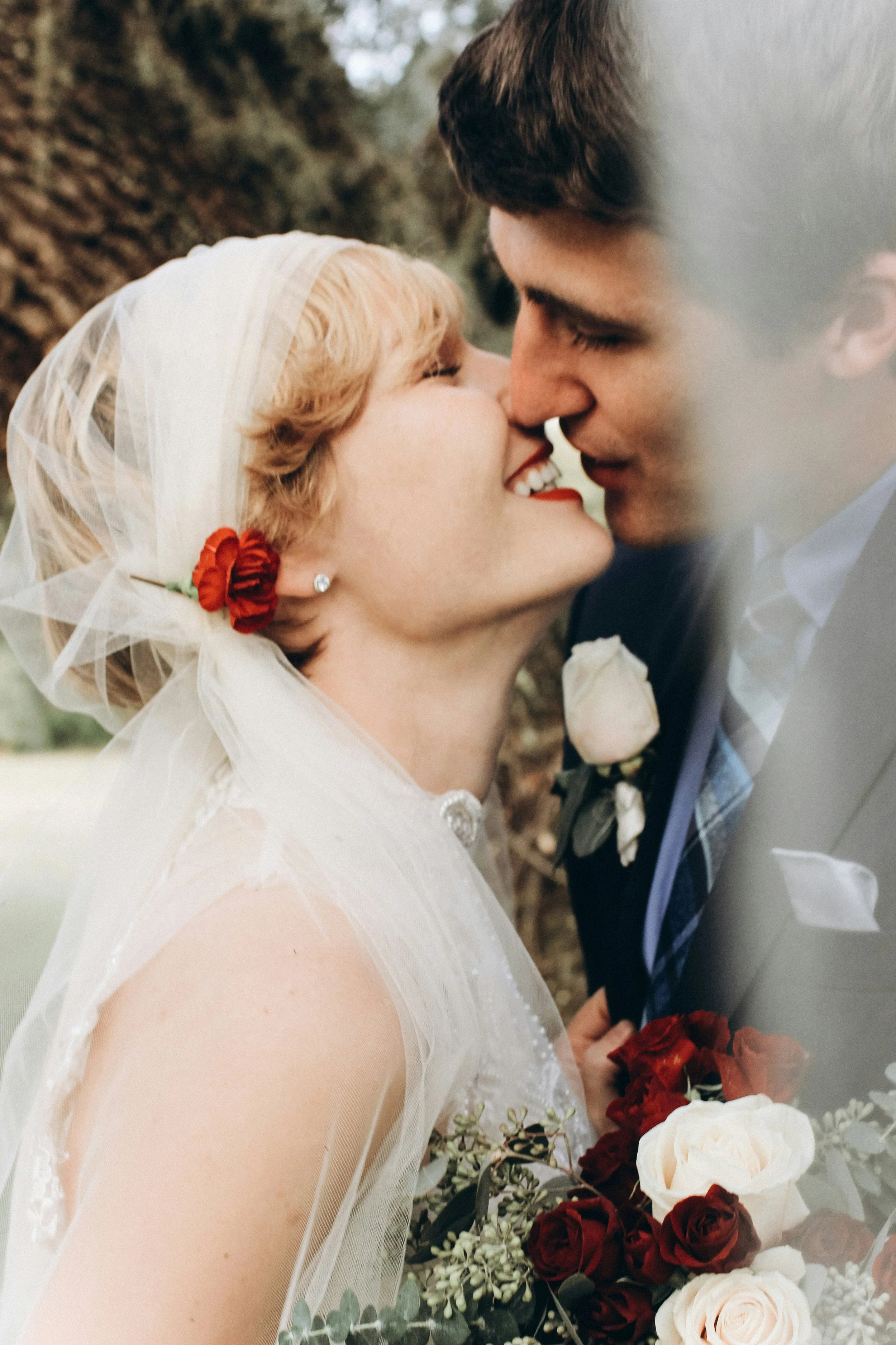 Laurie’s customers, Fernando and Kate embracing by the lake on their wedding day.