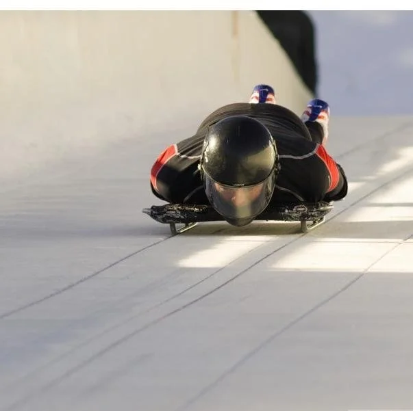 skeleton athlete starts his run in Olympic sport of skeleton