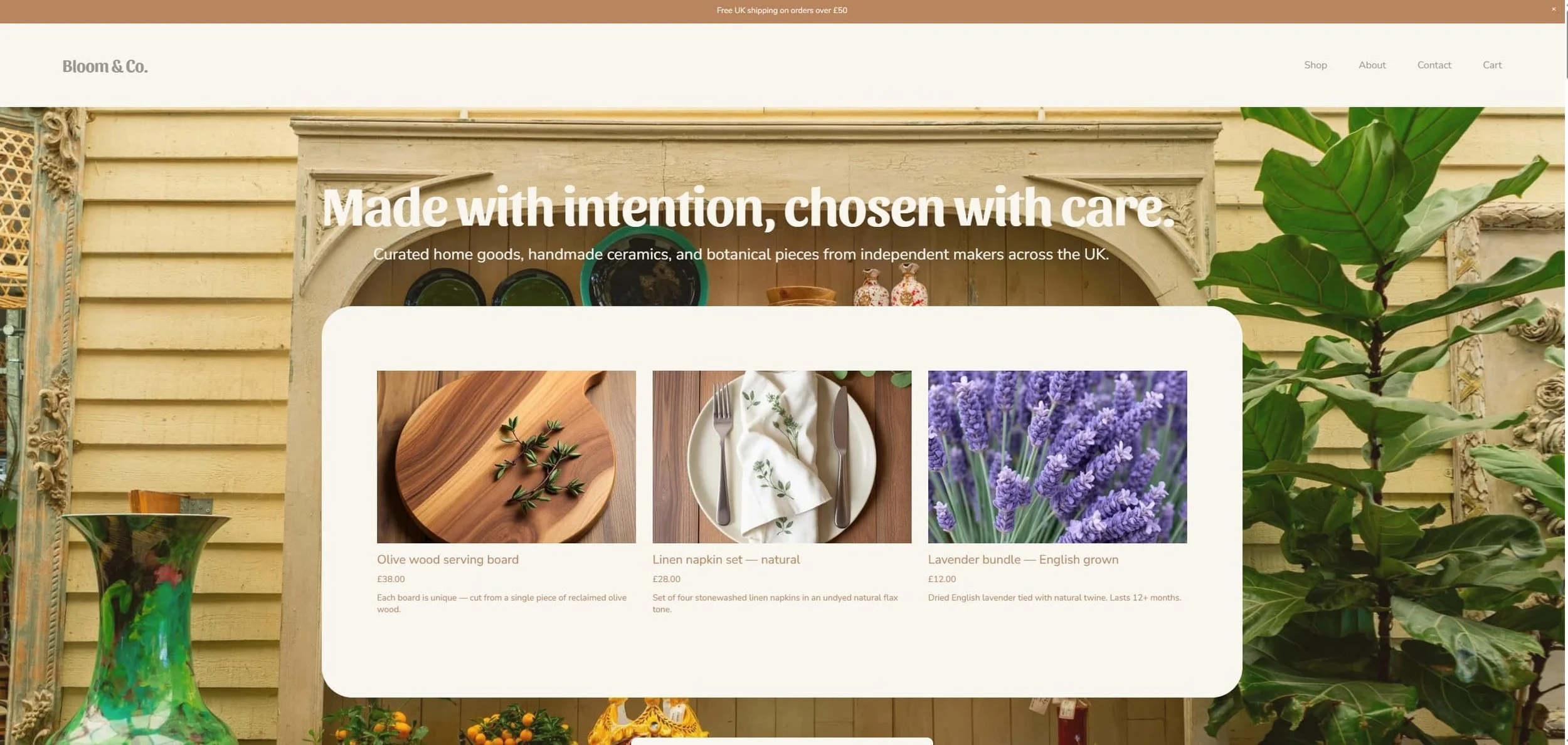 Home page of Bloom & Co. website showcasing curated home goods, handmade ceramics, and botanical pieces, with images of a wooden serving board with herbs, a linen napkin set, and a bundle of lavender, set against a background of plants and yellow-painted wooden walls.