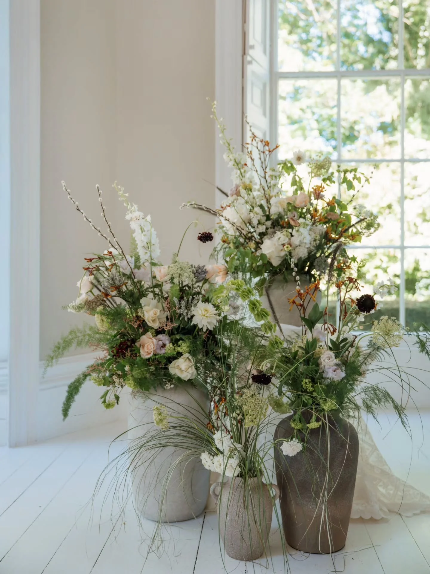 Framing the top of your ceremony aisle creates an instant focal point, drawing the eye exactly where it should be while adding depth and drama to your ceremony space. 

This design focused on creating interest through variation. Different vessels, di