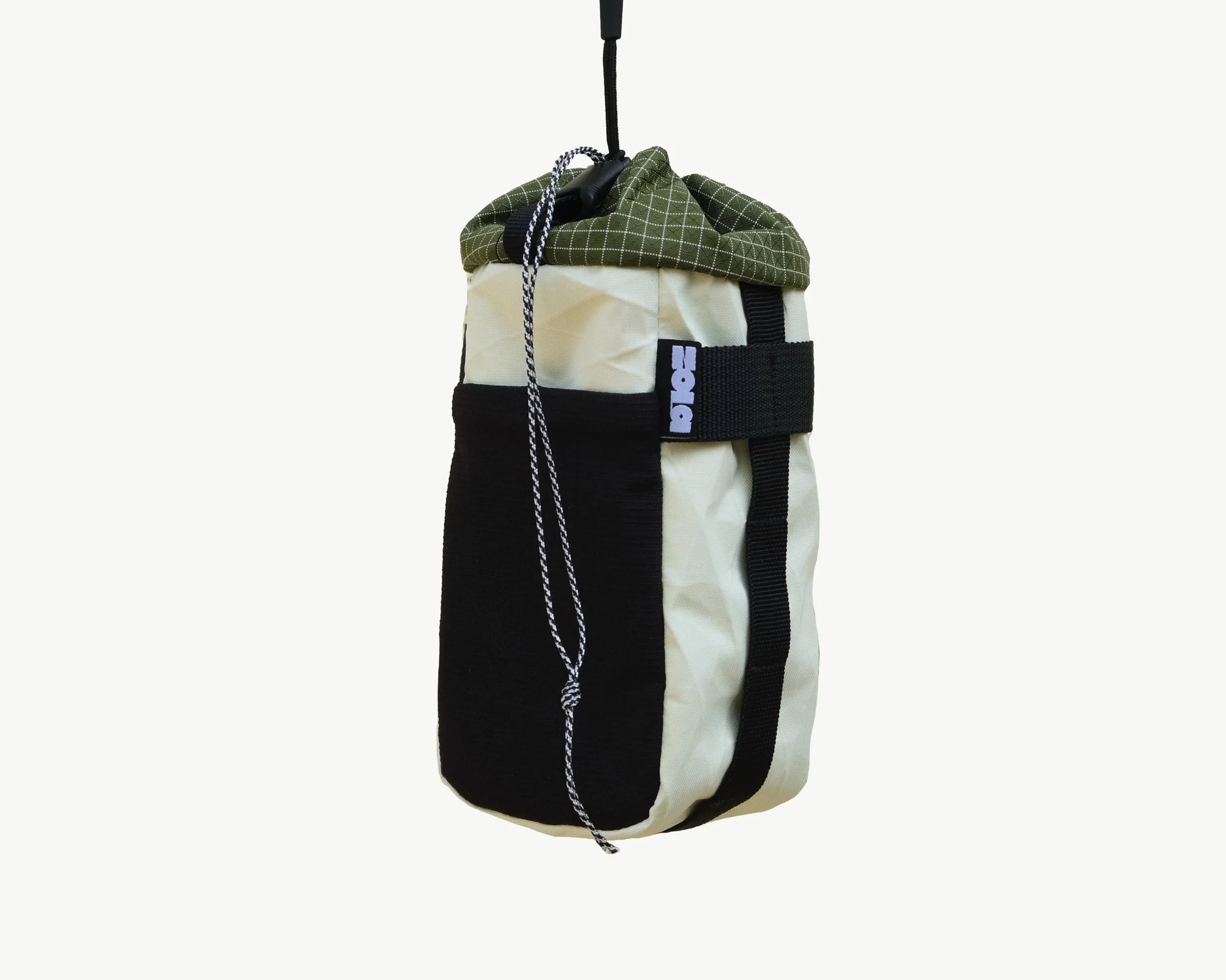 A hanging golf bag with clubs, featuring a green checkered top, beige and black body, and a black strap.