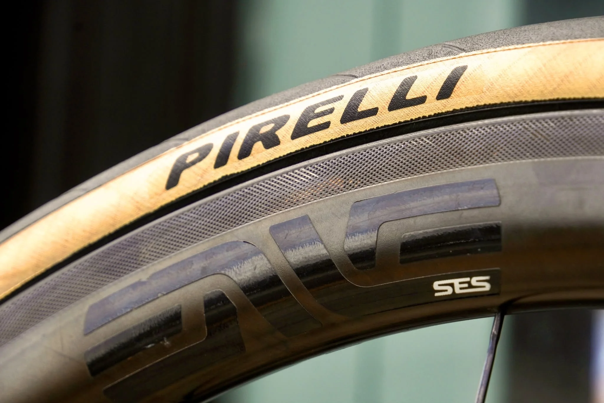 Close-up of a bicycle tire with a yellow band displaying the brand name 'PRELLI' and part of the tread pattern visible.