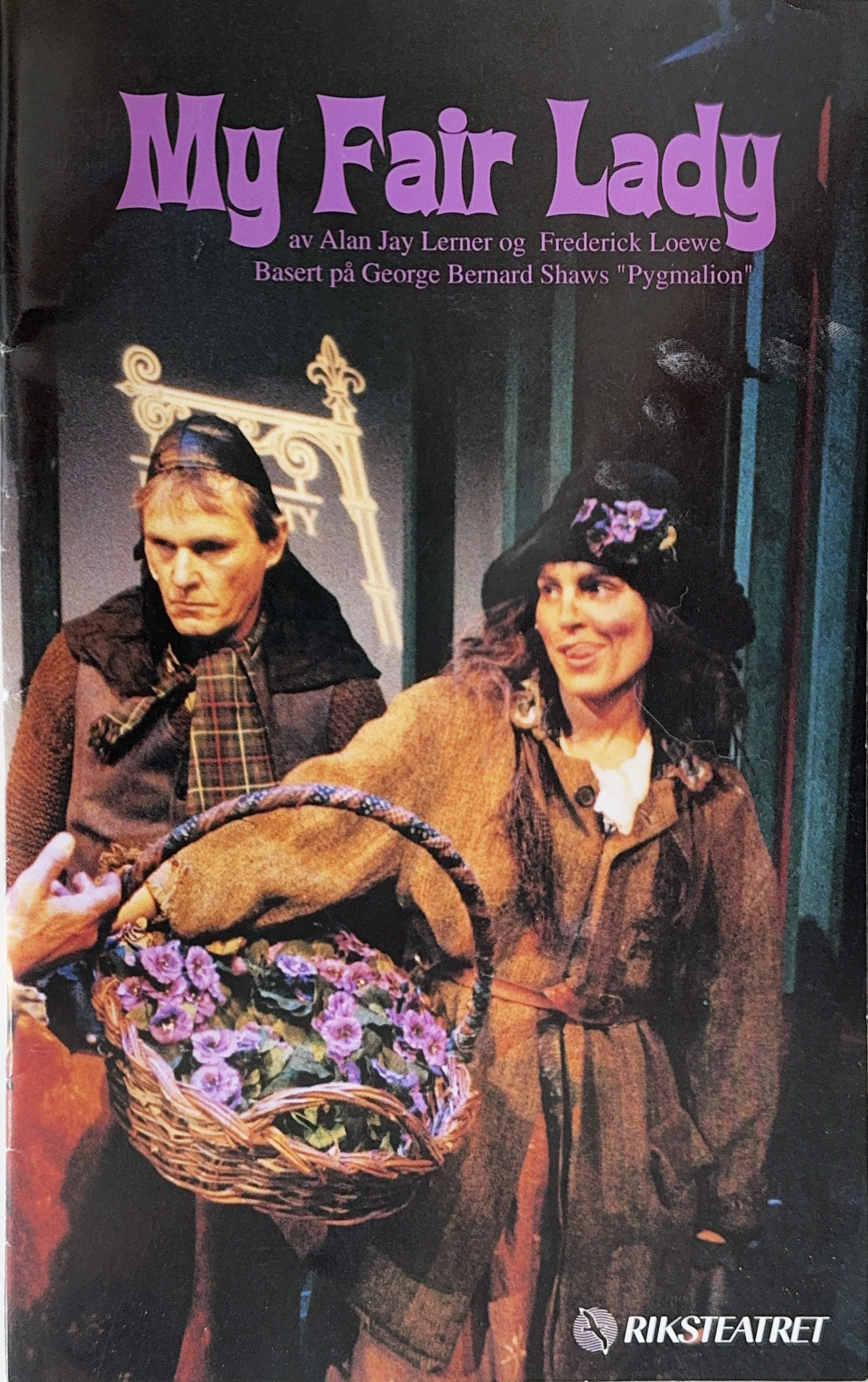 The cover of a playbill for "My Fair Lady" featuring two actors in costume, one holding a basket of purple flowers. The title is in large purple font at the top, and there is text crediting the creators and the source material. The playbill is from R