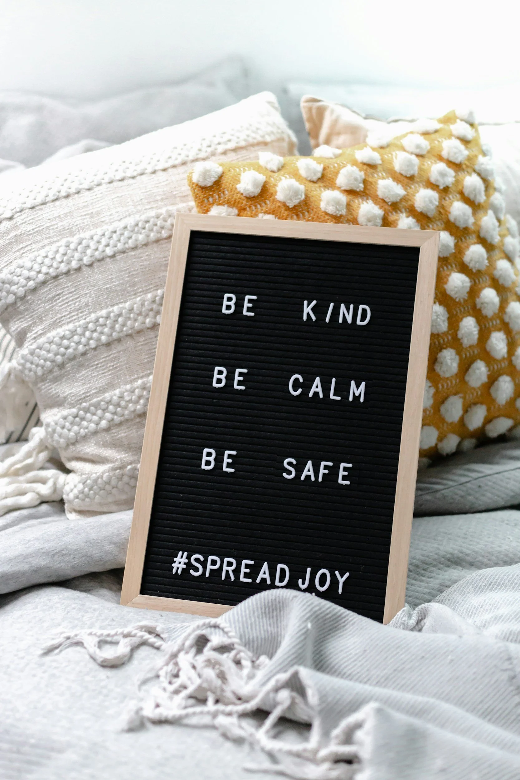 ramed letter board displaying the words "Be Kind. Be Calm. Be Safe. #SpreadJoy", surrounded by a welcoming seating area that reflects Human Edge Consulting's values of kindness, respectful leadership and human-centred practice.