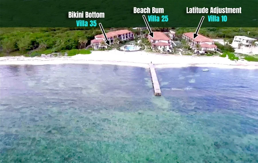 Aerial view of beachfront villas labeled Villa 35, Villa 25, and Villa 10 from left to right, with a dock extending into clear turquoise water and greenery in the background.