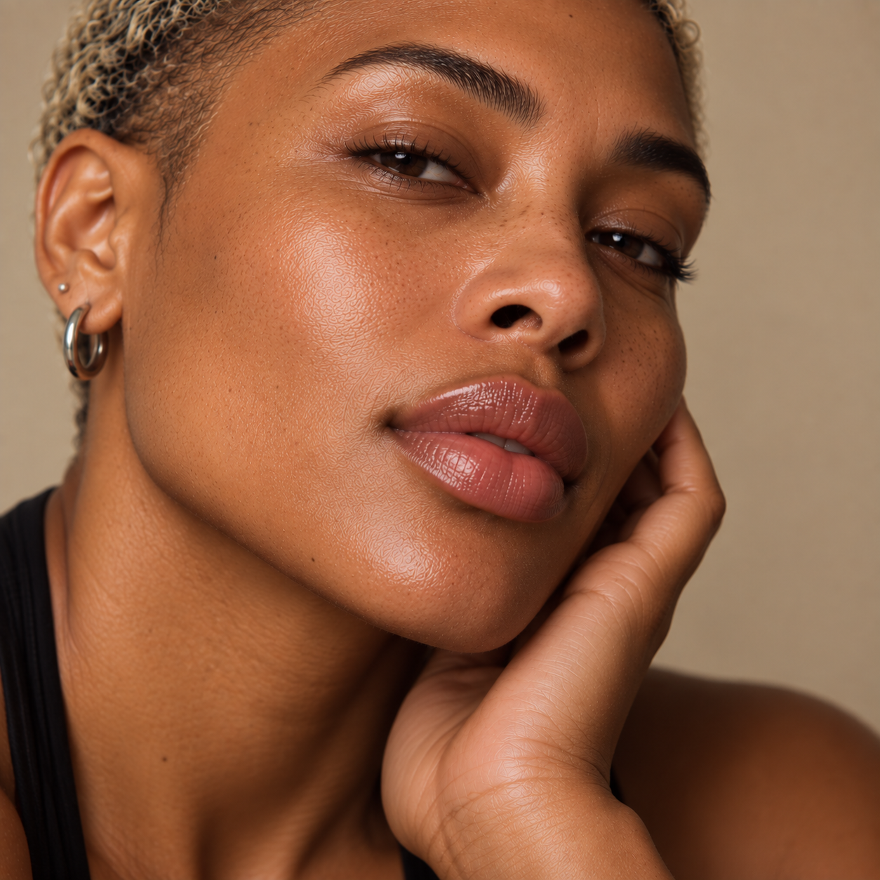 Close-up portrait of a Black adult with naturally full, glossy lips and radiant skin, representing personalised lip filler treatments for shape, definition and balance at LuxéPrive Aesthetics.