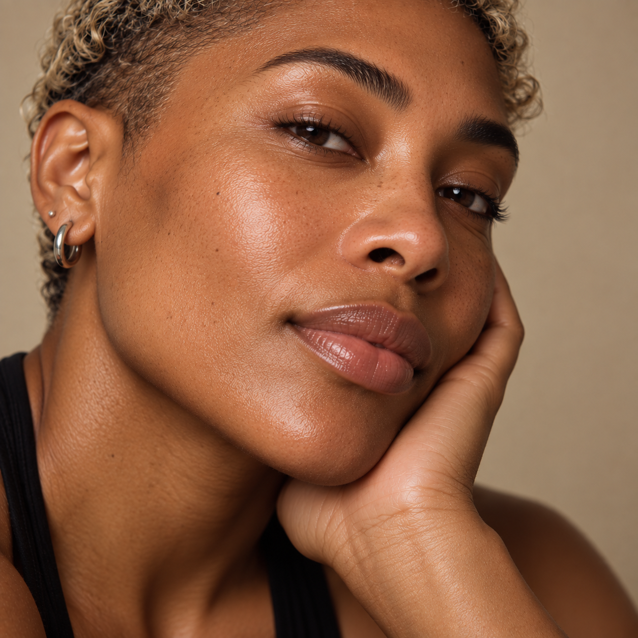 Close-up portrait of an androgynous person with smooth, dewy skin, representing micro-Botox skin booster treatments for refined pores, smoother texture and skin rejuvenation at LuxéPrive Aesthetics.