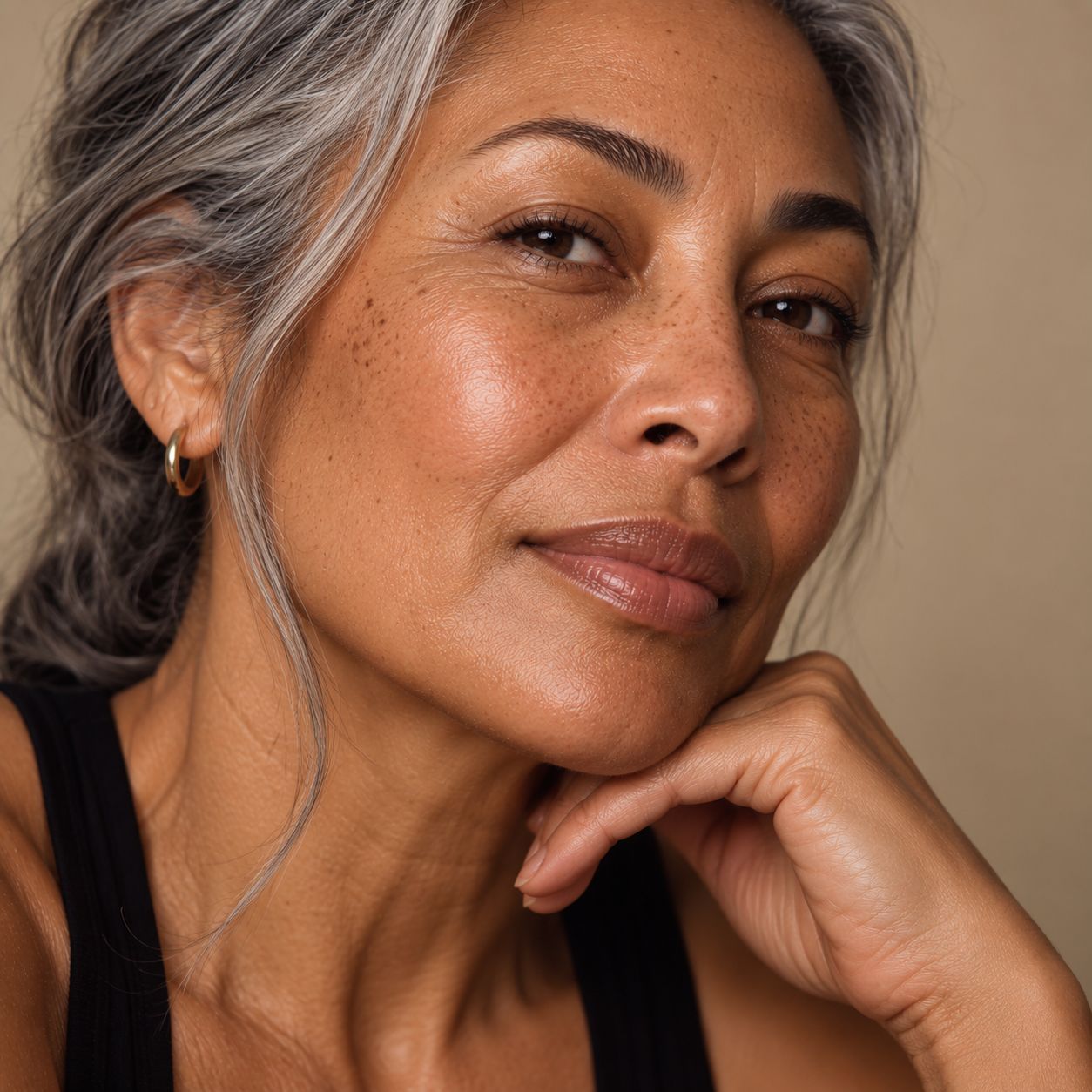 Close-up portrait of a mature woman with naturally textured, glowing skin, representing collagen-stimulating injectable treatments for supporting firmness and skin rejuvenation at LuxéPrive Aesthetics.