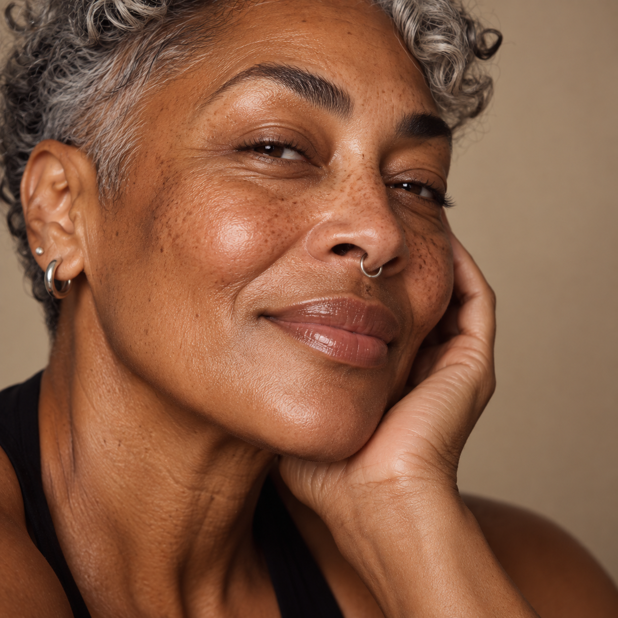 Close-up portrait of a mature person with hydrated, glowing skin, representing skin booster treatments for improving hydration, elasticity and skin quality at LuxéPrive Aesthetics.