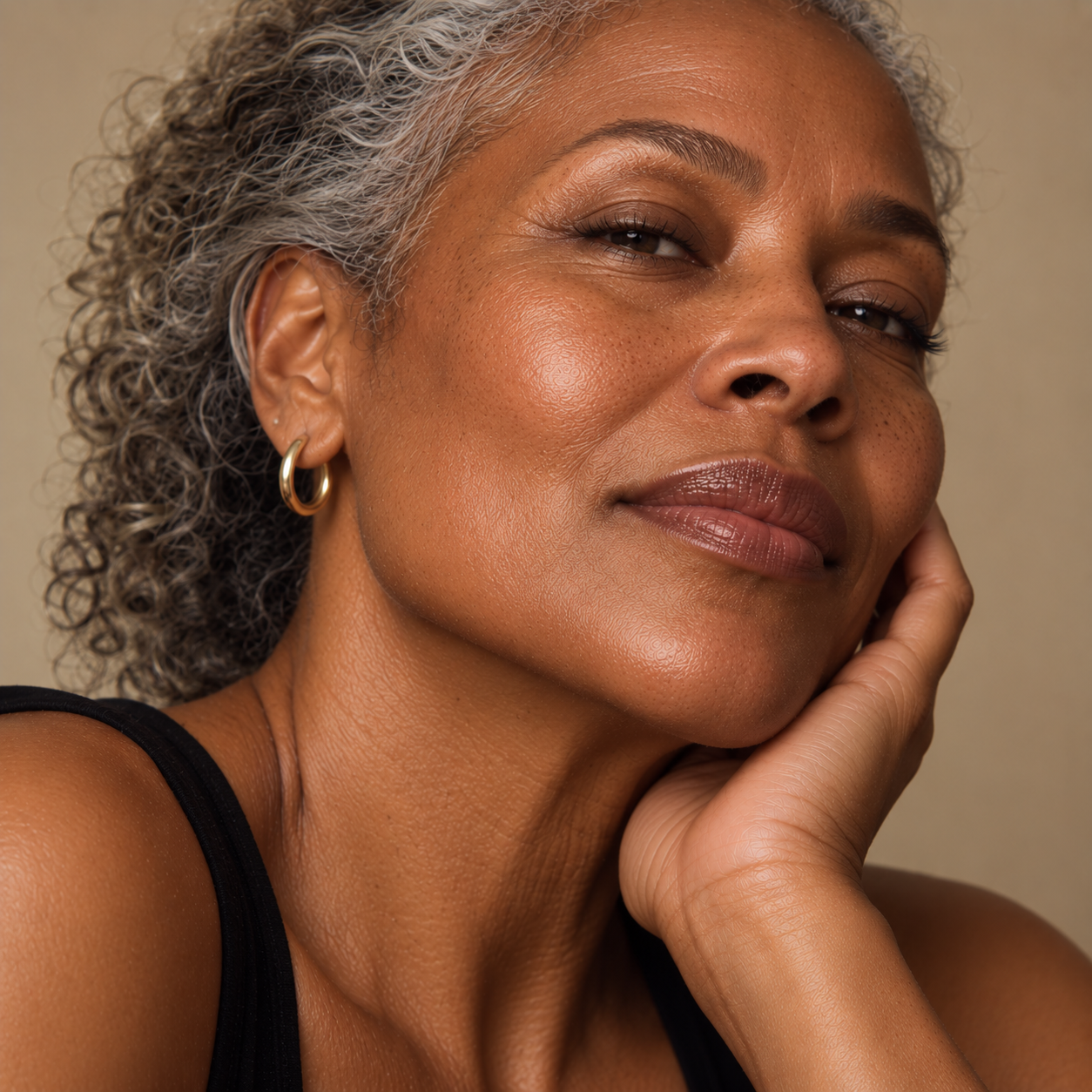 Close-up portrait of a mature Black woman with natural facial lines and radiant skin, representing dermal filler treatments to soften smile and marionette lines at LuxéPrive Aesthetics.