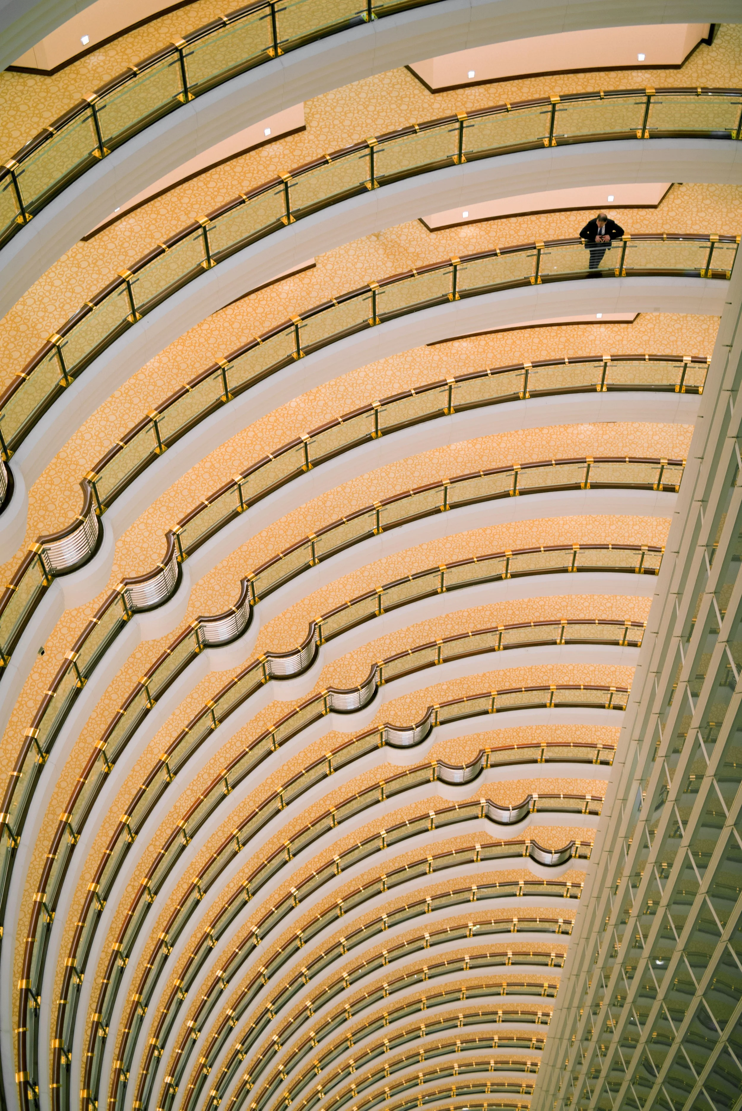 Architectural photography of the Grand Hyatt Shanghai interior atrium with curved balconies and patterned floors
