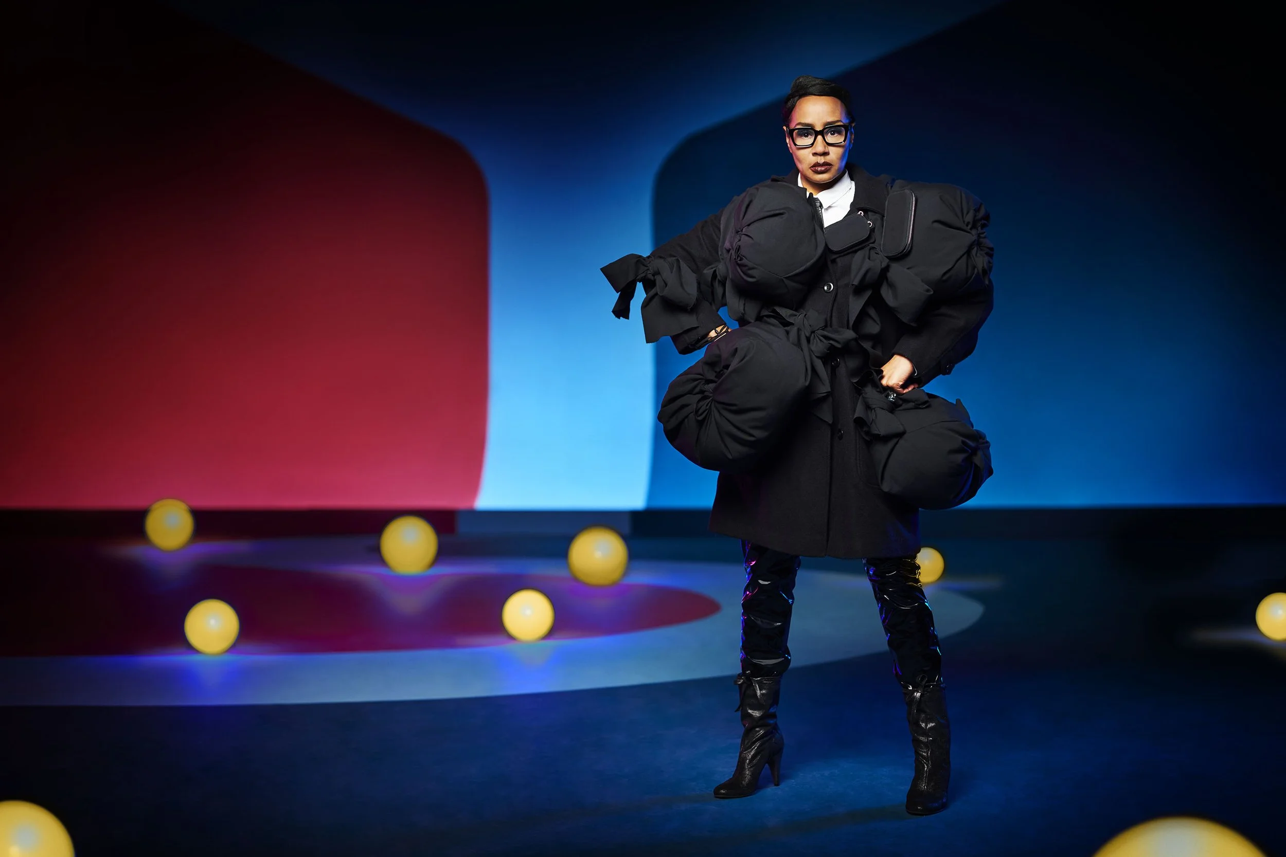 Commercial fashion portrait featuring contemporary styling and dramatic coloured studio lighting for advertising and apparel campaigns.
