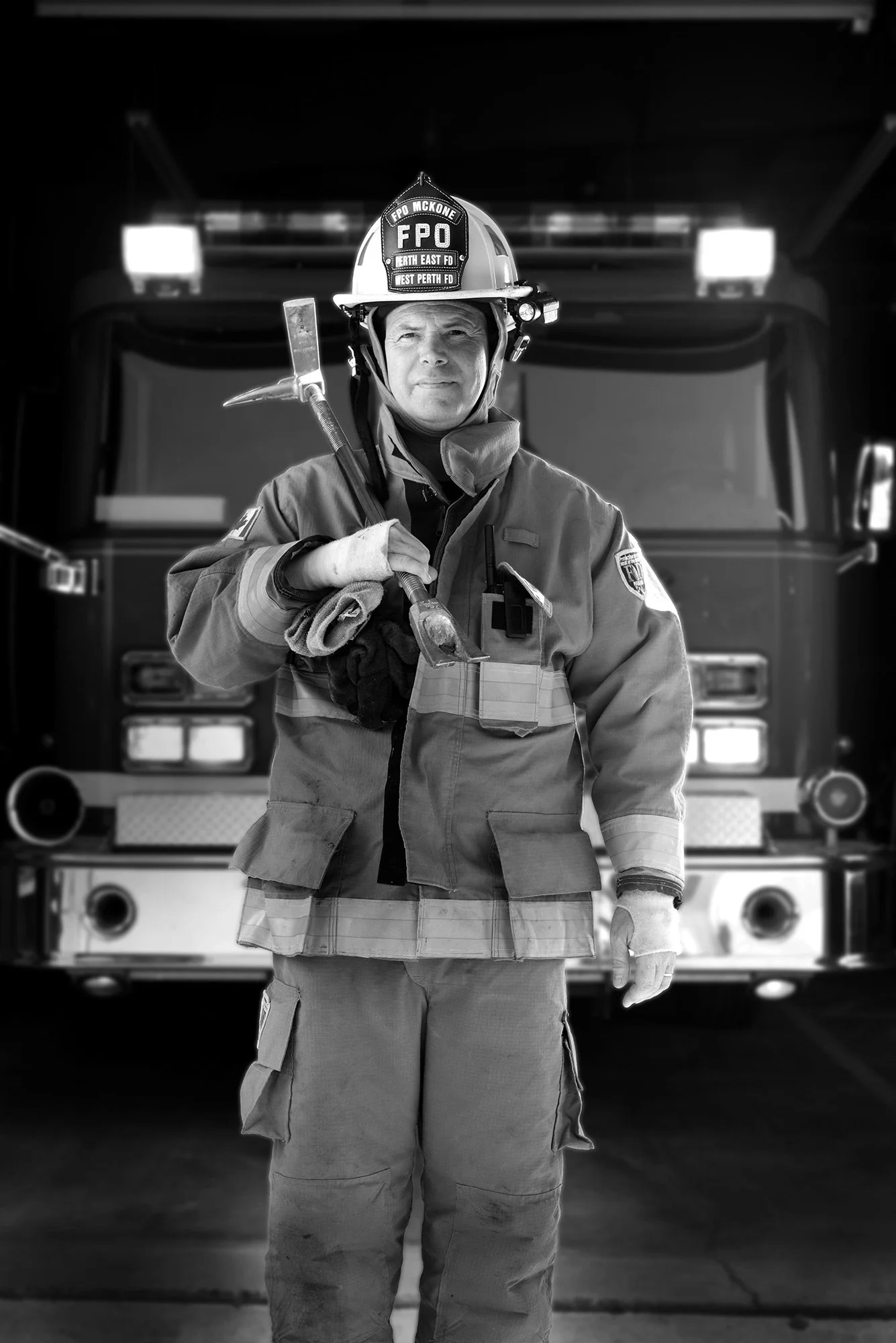 Annual report cover photography featuring a firefighter standing in front of a fire truck